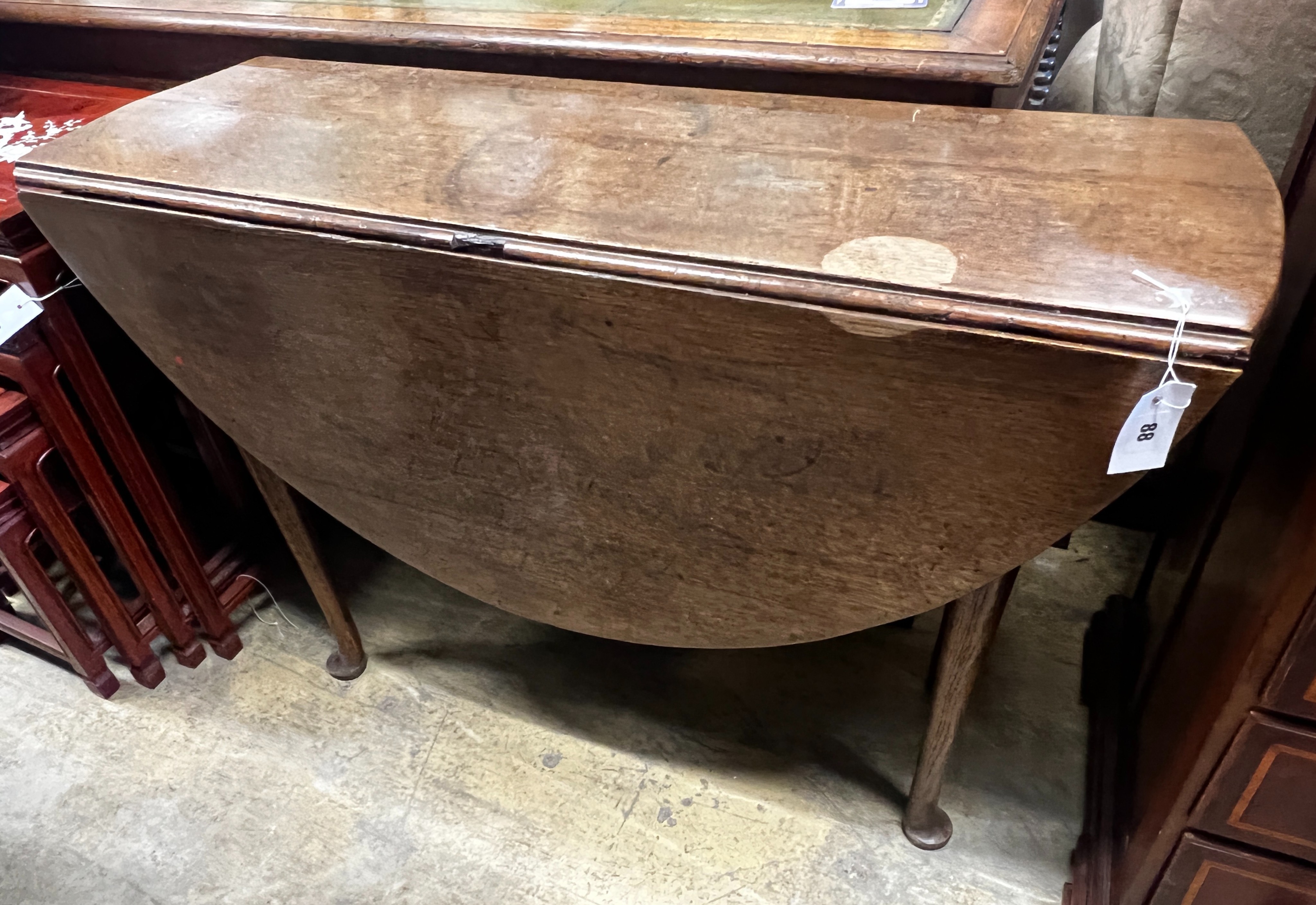 An 18th century oak drop leaf padfoot dining table, length 104cm, depth 37cm, height 72cm